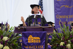 Honorary Poet Sonia Nazario speaks to graduates from the stage at Commencement.