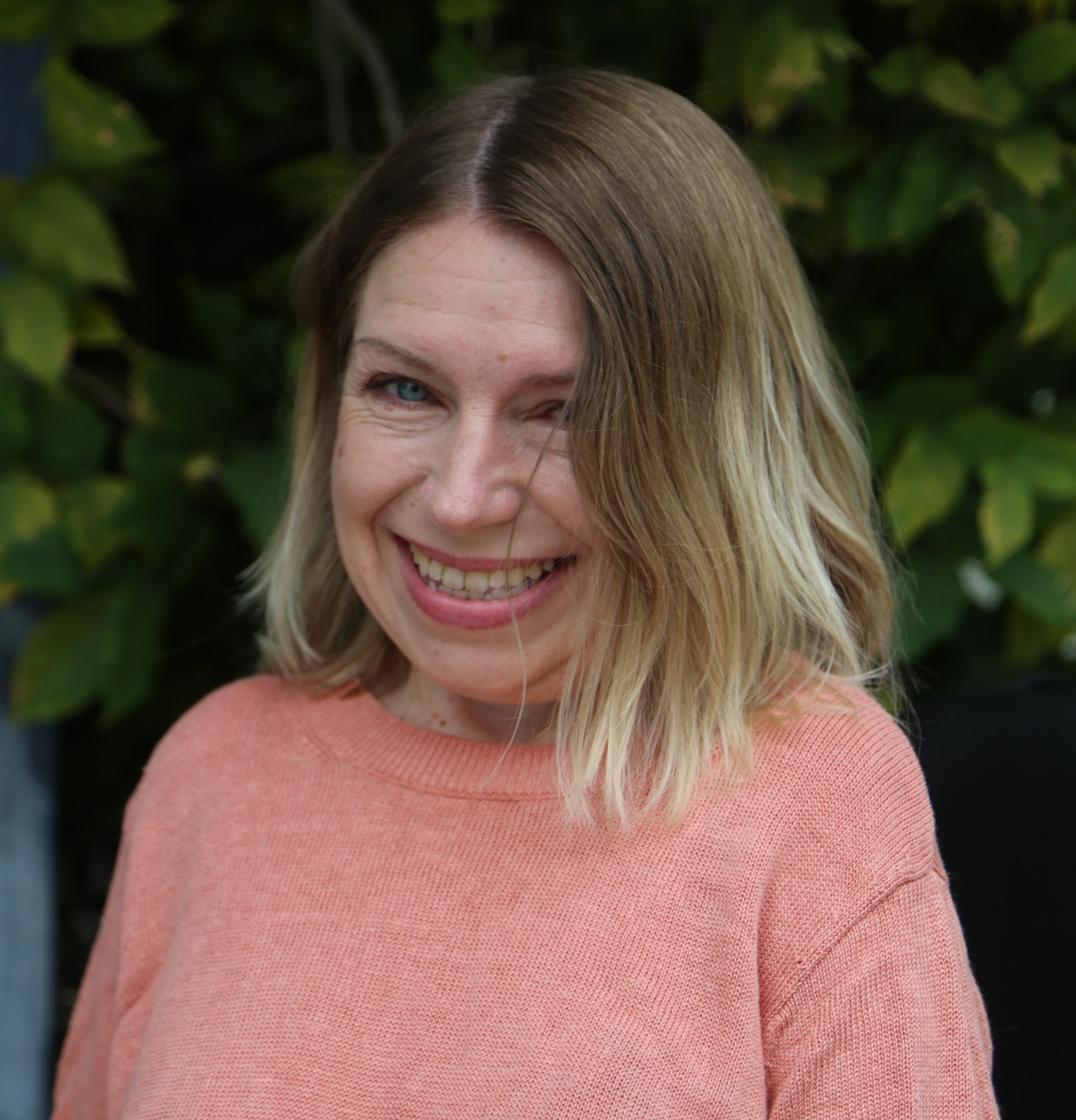Joanne Hash in front of plants