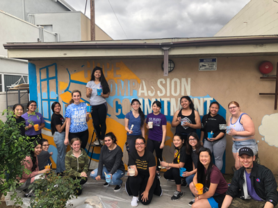 Volunteers painting mural