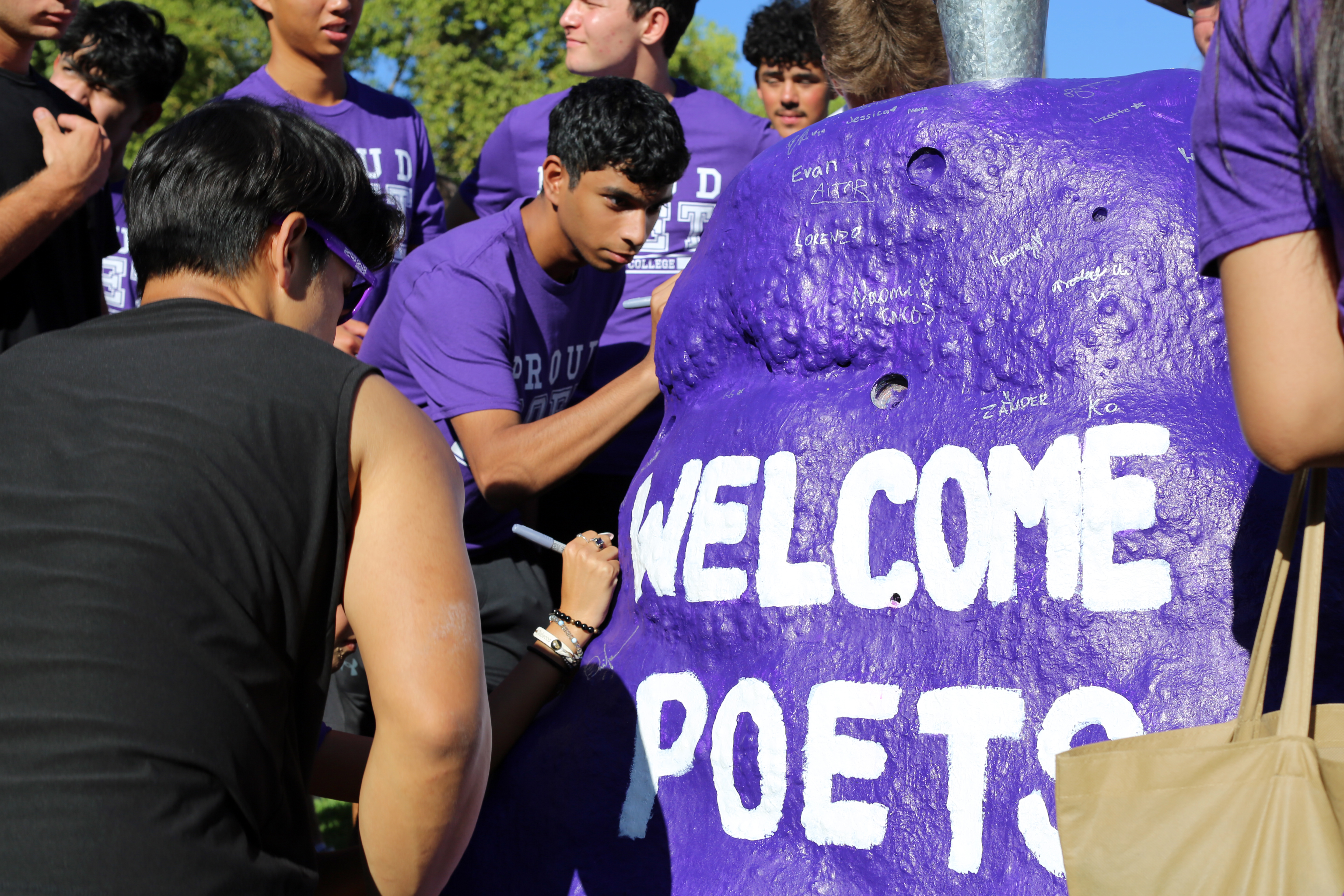 Students sign The Rock. 2024 | Whittier College