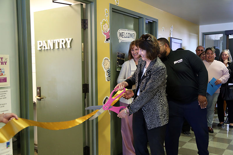 President Dillon cutting a ribbon