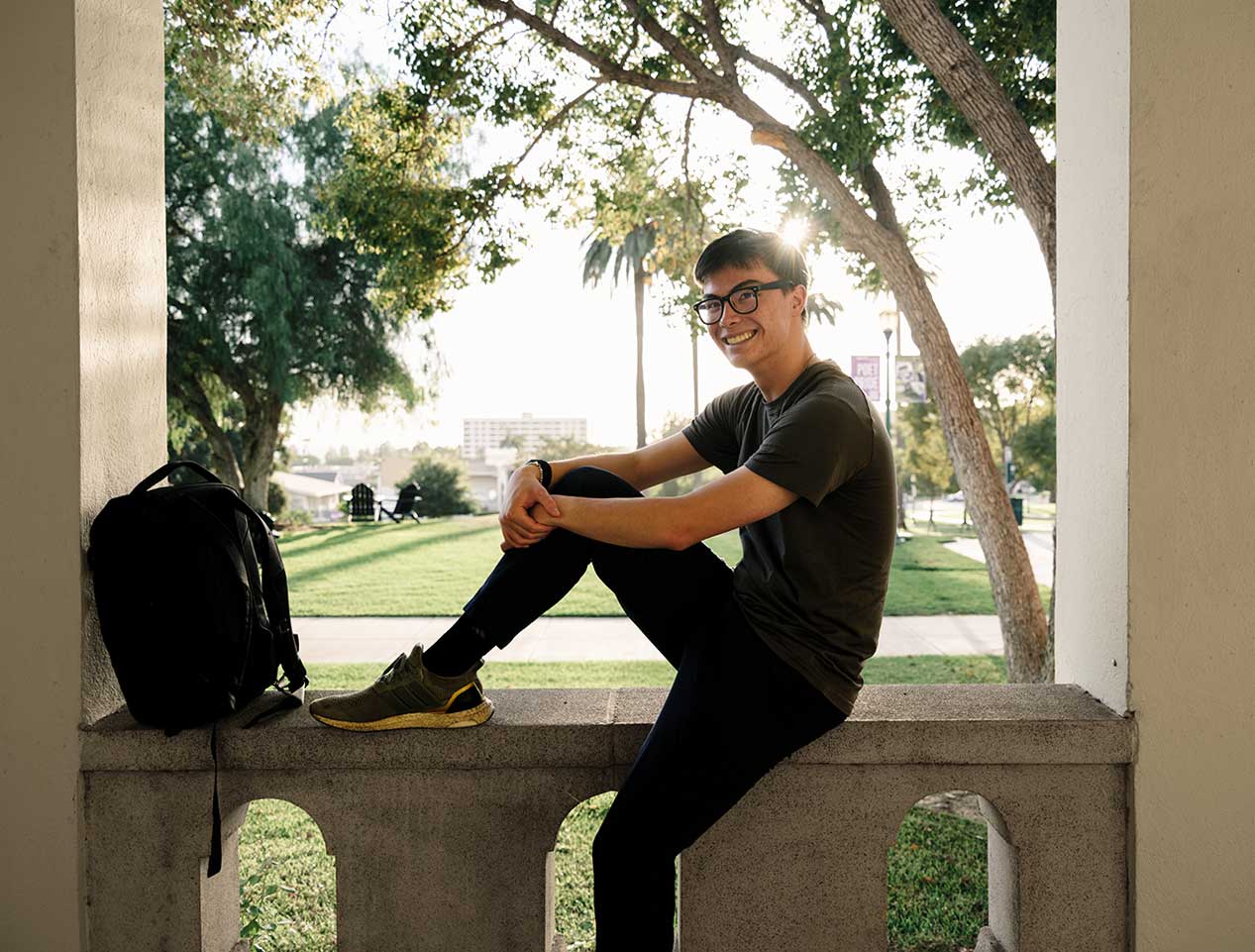 Student sitting in an archway