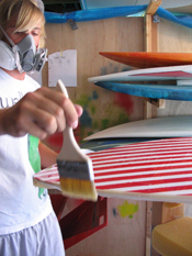 Jung works on his self-made surfboard