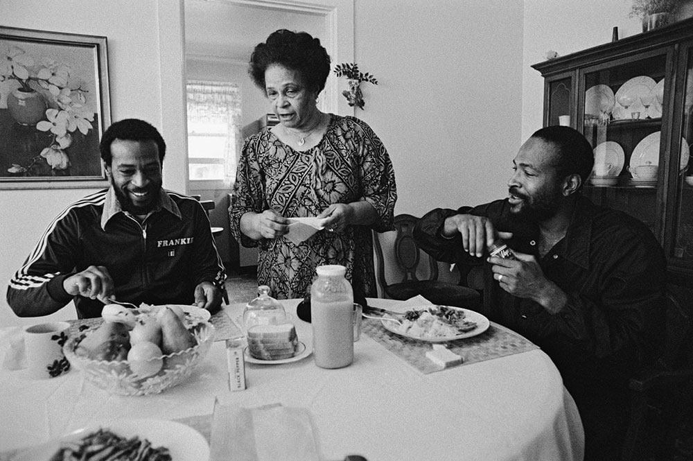 Three people sitting around a table.