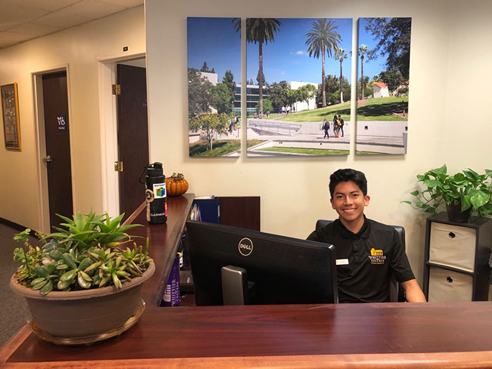 ricardo behind the admission front desk