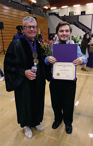 Professor Mike McBride and Caleb Britton, who is holding a certificate.