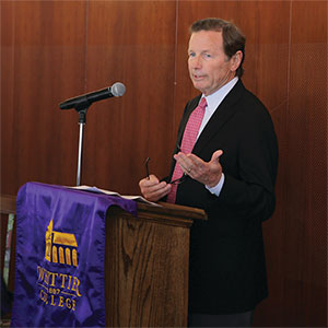 Rick Gilchrist gives a speech at a podium in Villalobos Hall.