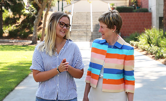 Sharon Herzberger walks alongside a student.