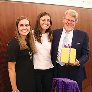 James Parks poses for a photo with two students.