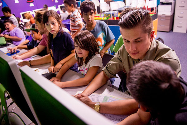 A Whittier College student works with children.