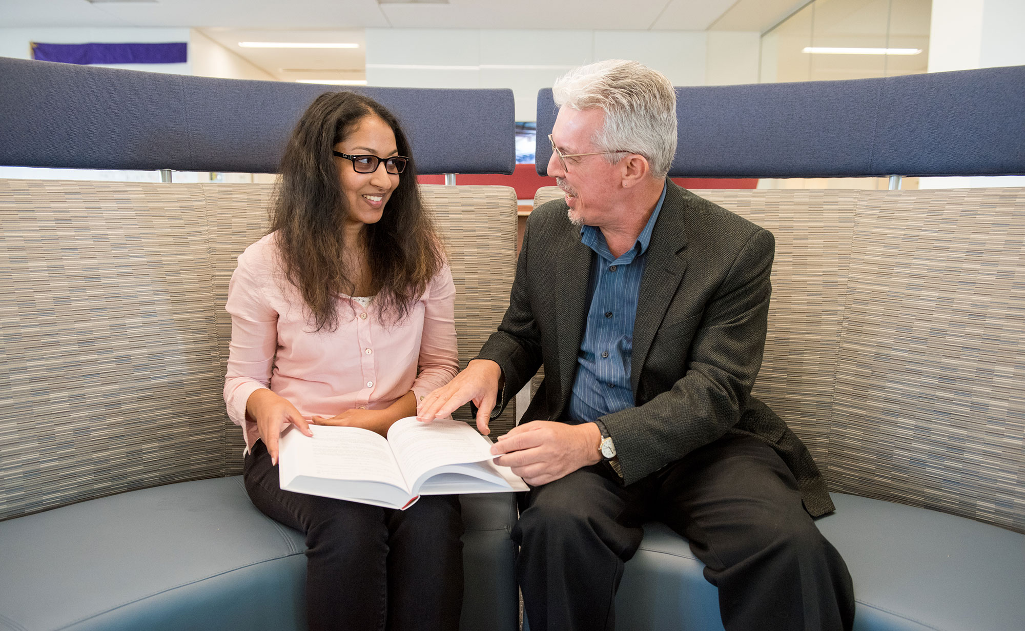 Student Supriya Bhupathy and Professor Seams Lagan share a book 