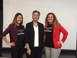 Kayla Kosaki, Elena Macias, and Jennifer Guerra stand in front of white board