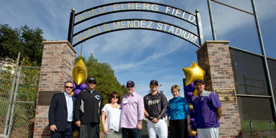 Group standing under sign