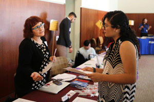 A student speaks with a representative at the career and internship fair