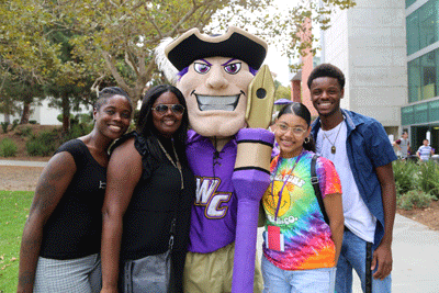 Four family members stand with a Poet Mascot in costume 