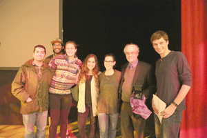 Students meet with Professor Stein on stage after a lecture