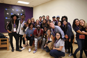 Students pose in a group photo with hip-hop artist, T-Pain