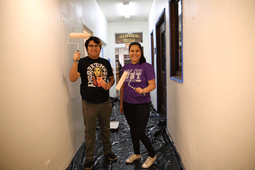 Volunteers painting a wall