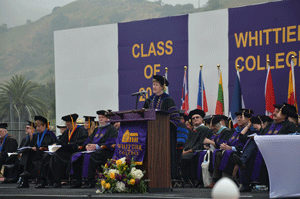 President Herzberger at the podium addressing the graduating class