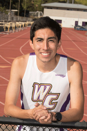 Student Ruben Solorza stands on the track