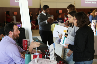 students speaking to a representative