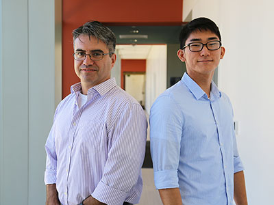 Hector Valenzuela and Brandon Choi in a hallway.