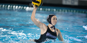 female water polo player in the pool ready to throw ball