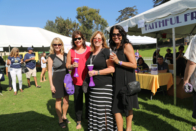 Four women standing together smiling