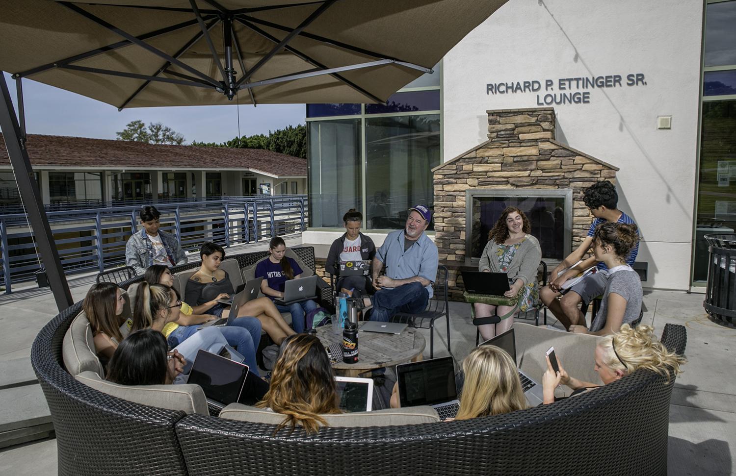 Students sitting in front of lounge at Whittier College campus