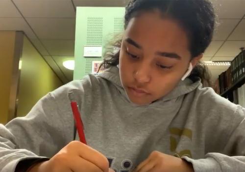 Nicole studying in the library