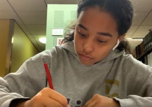 Nicole studying in the library