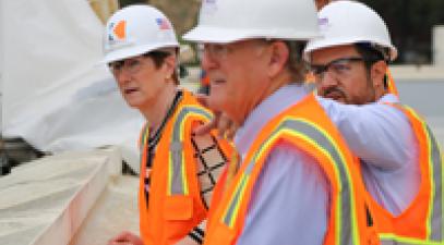 Picture of President Sharon Herzberger and Whittier College officials donned hard hats 