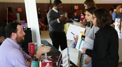 students speaking to a representative