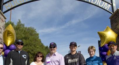 Group standing under sign