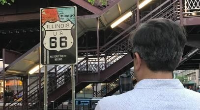 Miguel Santana looking at a Route 66 sign at the fair