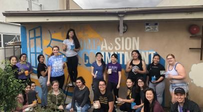 Volunteers painting mural