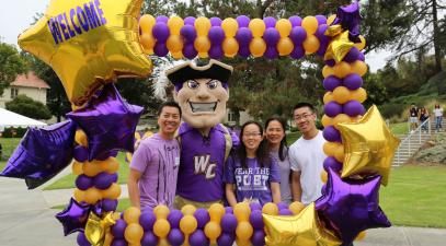 a family of four with mascot Johnny Poet