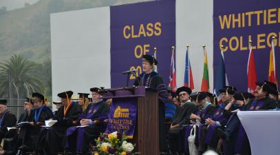President Herzberger at the podium addressing the graduating class