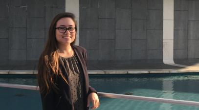 Jacklyn Waight, stands in front of a fountain and the back part of the Mark Taper Forum