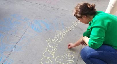 Student writing with chalk.