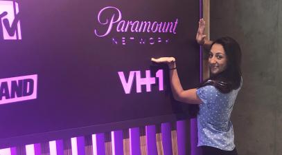 Madison Crimi-DeMichele stands in front of a Paramount Network sign.