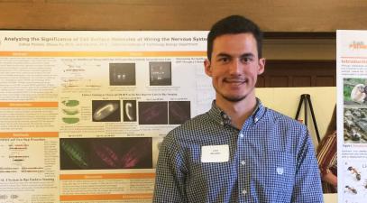 Joshua Morales stands in front of his neurobiology presentation.