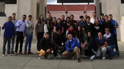 A sports management class poses as a group at the entrance of the L.A. Memorial Coliseum.