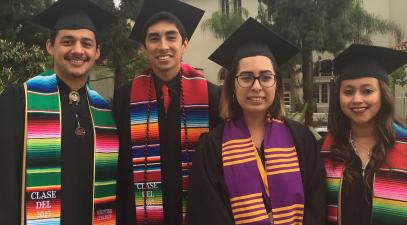 Latino Graduates pose in caps and gowns