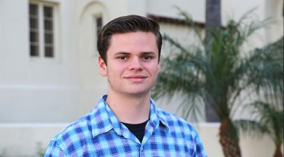 Luke Holbert stands in front of Mendenhall.