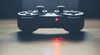 A Playstation controller on a table.