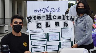 two student with poster: Pre-health club
