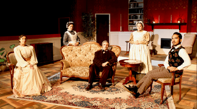 Several student actors pose for a photograph on the set of "Gaslight."