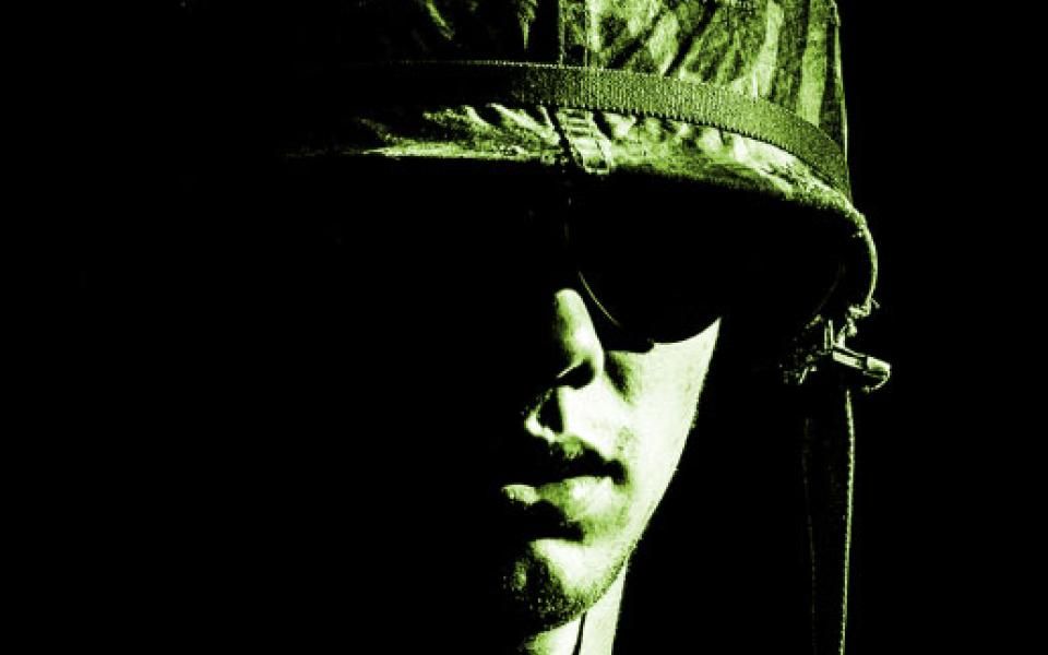 Cover of "Club Saigon," depicting the face of a soldier.