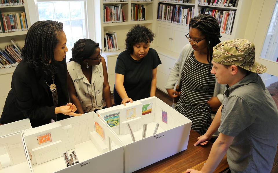 Rosalba Ponce in front of a display, surrounded by four people.